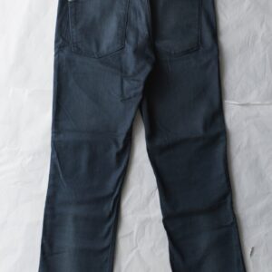 blue denim jeans on white textile